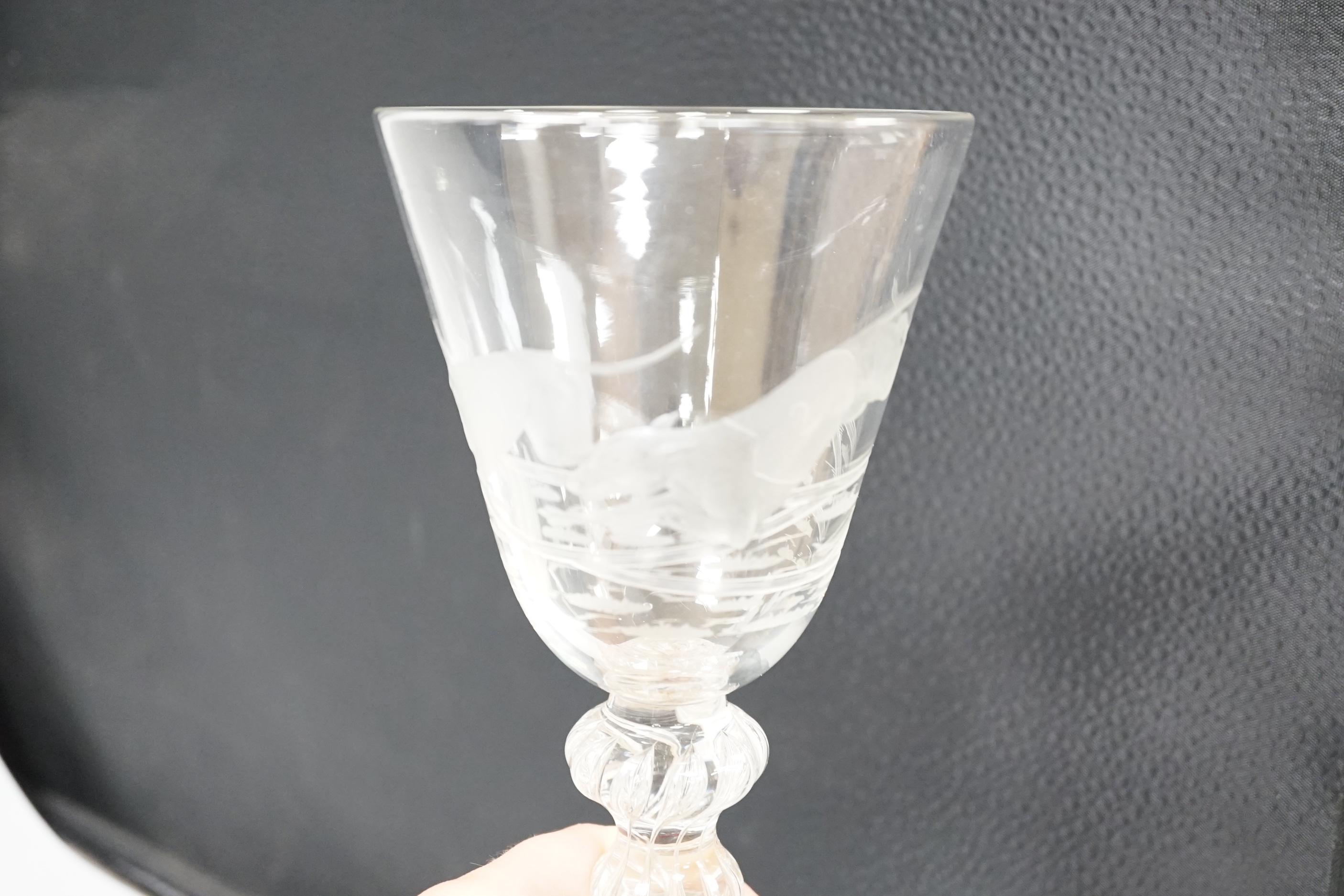 An English lead crystal mammoth trophy goblet, 19th century / early 20th century, engraved with two racing greyhounds, coats numbered 1 and 2, leaping a hurdle, four knopped multiple teared stem and a wide foot with brok